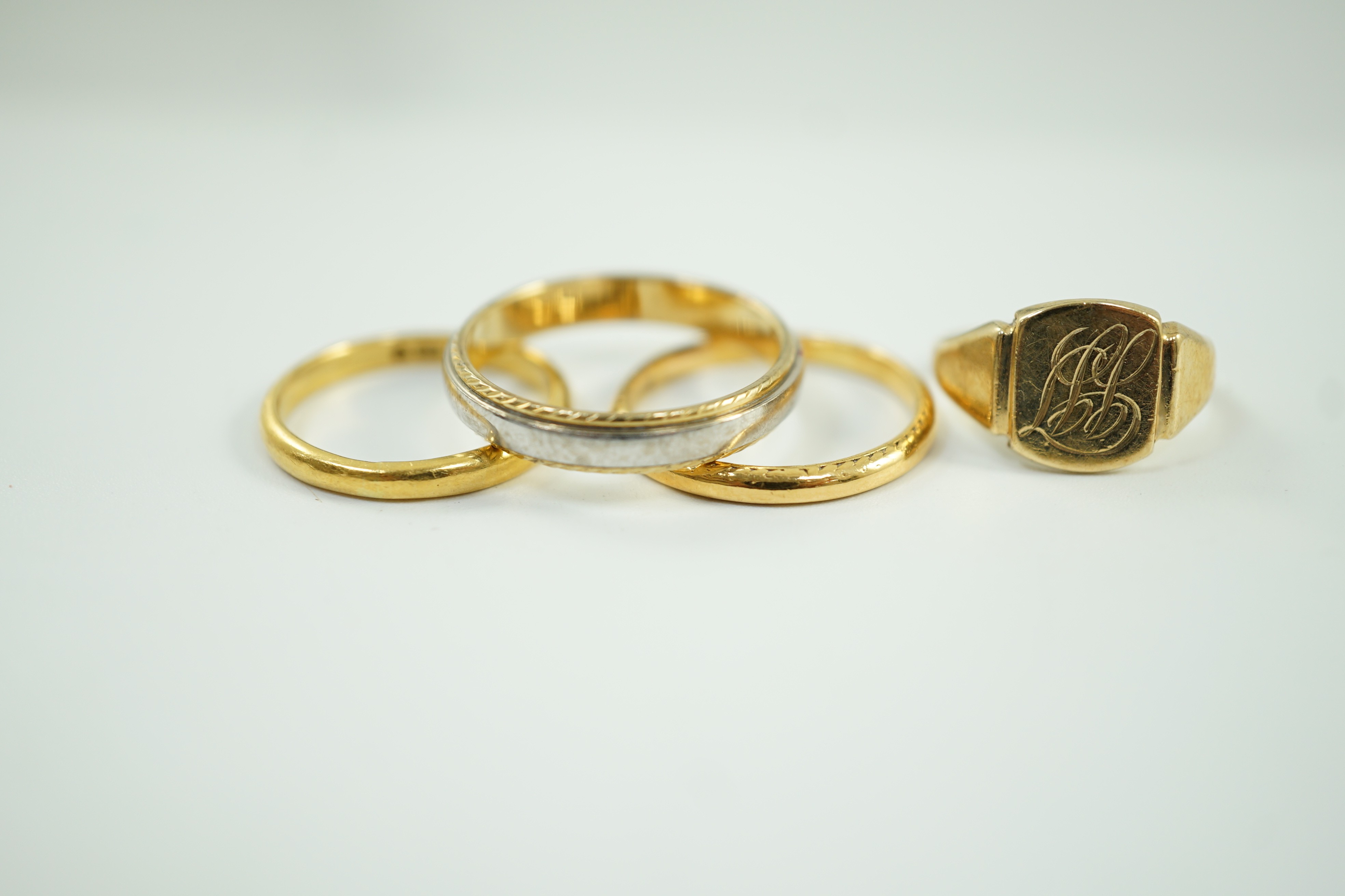 Two 22ct gold wedding bands, 5.2 grams, a 9ct gold signet ring, 2.4 grams and a two colour 750 yellow metal band, 4.4 grams.